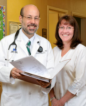 Mid-career hospitalist Scott L Oxenhandler ACP Member with medical assistant Denise Adams